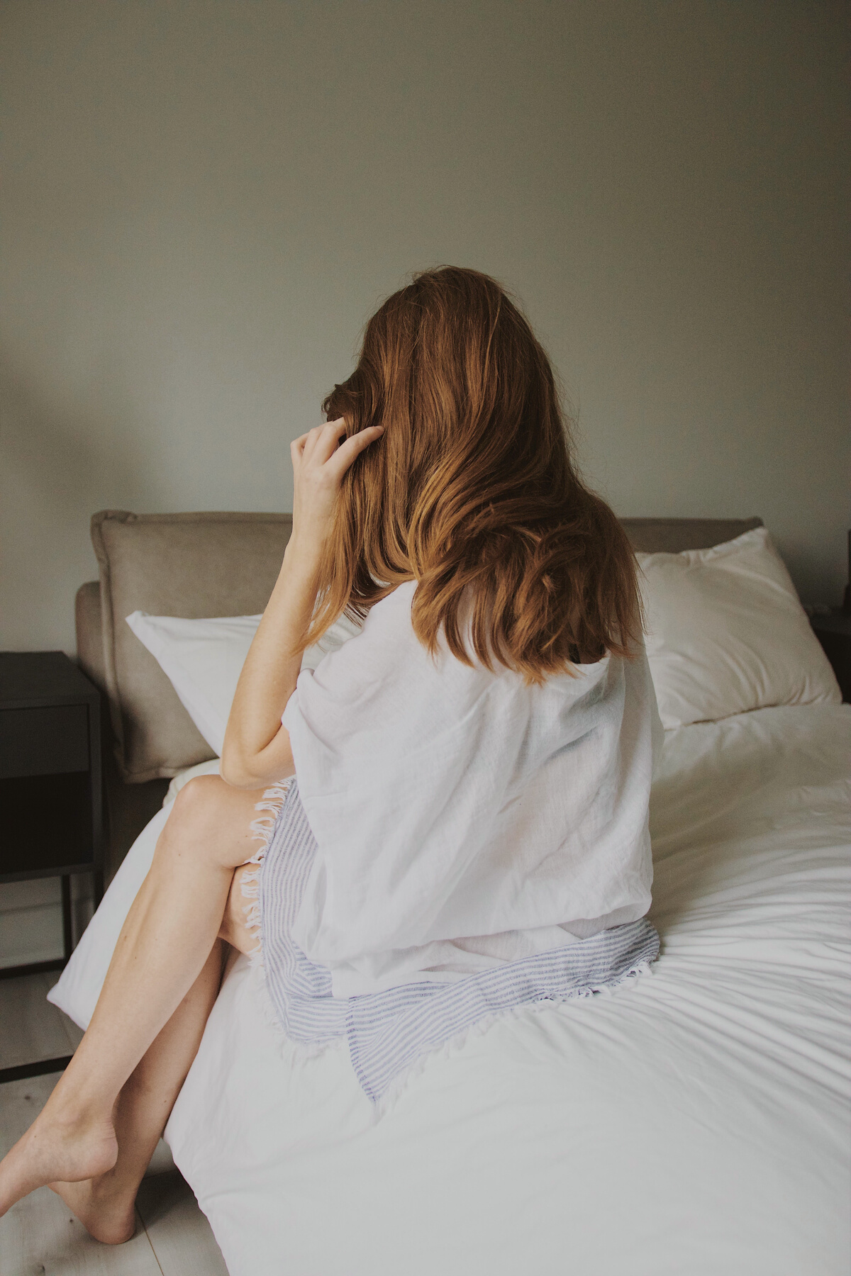 Woman in White Dress Lying on Bed